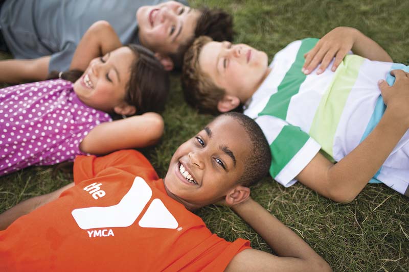 YMCA Kids Laying in Grass